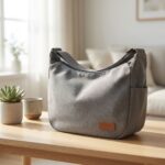 Sac De Transport Pour Chien Bandoulière gris sur une table en bois